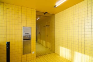 A retro bathroom with two sinks, ceramic tile walls and floor, and a classic design