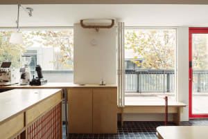 Warm and inviting kitchen space with wooden cabinets, a dining table, and natural light from a window