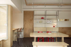 Open dining area with a wooden table and red chairs, suggesting a cozy and inviting atmosphere for gatherings and meals