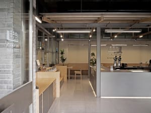 Bright and inviting open concept kitchen and dining area with a large window, sleek lines, and minimalistic decoration