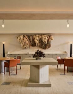 Elegant dining space with wooden furniture, wine glasses, and comfortable seating for guests