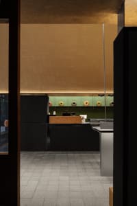 Office space with wooden floors and walls, featuring a countertop with three donuts, conveying a calm and organized atmosphere
