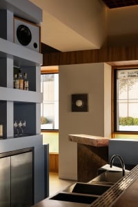 Modern kitchen and dining space with a countertop, sink, refrigerator, dining table, and chairs, with a well-stocked kitchen and inviting atmosphere