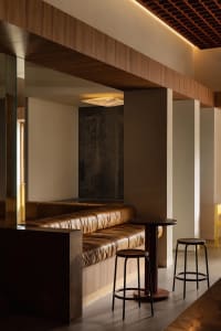 Cozy living space with a large couch, two chairs, a dining table, and leather furniture, creating a luxurious atmosphere