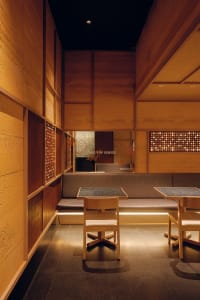 Warm and inviting restaurant interior with wooden walls and tables, comfortable seating, and a cozy atmosphere