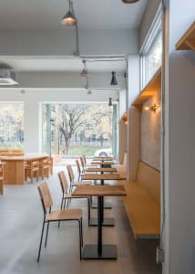 Empty restaurant with wooden tables and chairs, inviting and comfortable atmosphere, warm and cozy feel