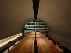 Warm and inviting restaurant interior with wooden tables and benches, soft ambient lighting, and a cozy atmosphere