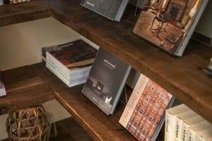 A bookshelf filled with various books on different subjects, including architecture, in an intellectual environment