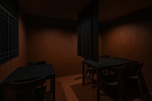 A warm and inviting dining area with a long wooden table surrounded by chairs and brick walls