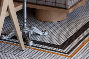 Cozy living space with a checkered tile floor, two chairs, and a dining table, creating a warm and inviting atmosphere