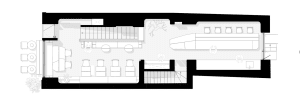 A well-lit interior space with multiple chairs, dining tables, and a couch, creating a welcoming atmosphere