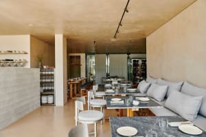 Elegant dining space with wooden tables, wine glasses, and comfortable seating for guests