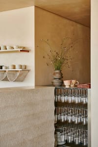 A cozy bar area with wine glasses, cups, and bowls arranged on a counter, creating a welcoming atmosphere for socializing and relaxation