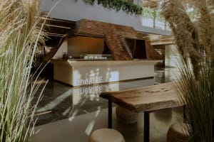 Inviting restaurant interior with a modern bar and dining area featuring a countertop, chairs, and contemporary design elements