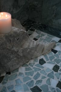 Bathroom with a stone tile floor featuring a unique animal design, marble tiles, and an elegant atmosphere