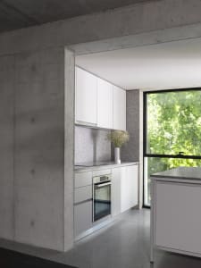 Modern kitchen with white cabinets, a window, and a sink, with two vases on the countertops