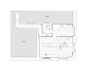 White floor plan drawing on a black background showing a modern house with a living area, kitchen, dining area, and bedroom, featuring furniture placement and dimensions