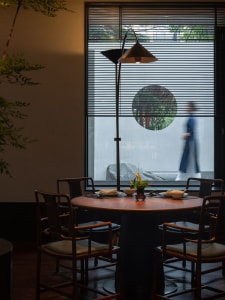 Cozy dining area with a round table surrounded by chairs, set with bowls, and an inviting atmosphere