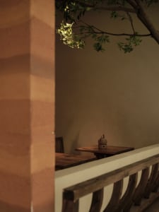 Cozy dining area with a wooden table and chairs, set up for a meal in a restaurant or cafe setting