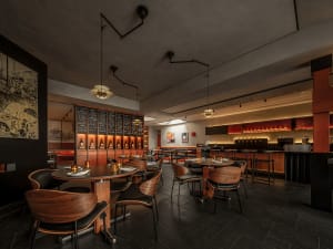 Empty restaurant with wooden floors and tables, featuring modern design and minimalistic decorations
