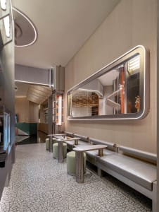 A restaurant dining area with a wooden table and chairs, creating a cozy and inviting atmosphere for socializing and meals