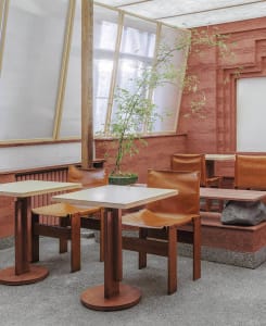 Warm and inviting restaurant interior with wooden tables and chairs, encouraging social interaction among diners
