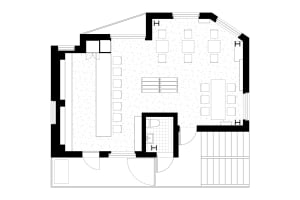 Black and white floor plan of a hotel with various rooms and spaces, including a lobby and dining area