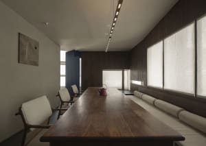 A well-lit dining area with a wooden table and chairs, creating a warm and elegant atmosphere