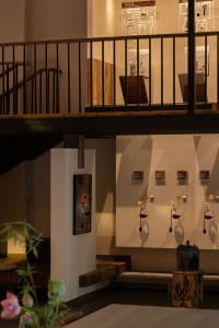 A museum-style interior with artworks on the walls and sculptures throughout, creating a space for art appreciation