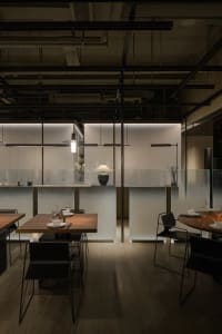 Elegant restaurant with glass walls, wooden floors, and minimalist decoration, featuring multiple dining tables and chairs