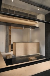 A warm and inviting kitchen space with wooden elements, sink, cabinets, and countertops