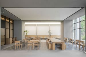Empty restaurant with wooden tables and chairs, clean and well-organized space with a warm ambiance
