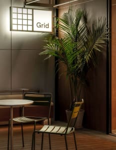 A cozy dining space with a table surrounded by chairs, a potted plant, and a vase, creating a warm and inviting atmosphere for socializing and meals