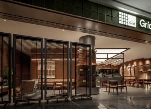 Warm and inviting restaurant interior with wooden floors and walls, featuring multiple chairs and dining tables