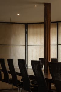 A calm and inviting dining area with a wooden table and chairs, surrounded by empty space