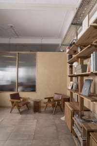 Cozy reading space with two chairs, a small table, and three books, set in a warm and inviting atmosphere