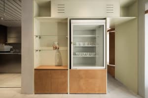 A warm and inviting kitchen with a white refrigerator, brown cabinets, and a countertop, featuring a sink near the right side