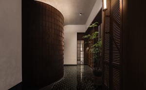 A calm and inviting hallway with a black and white checkered tile floor, two potted plants, and a chair