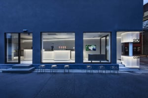 Empty modern restaurant with a large window, chairs, and a TV screen, featuring a clean and inviting atmosphere