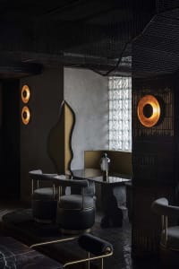 Modern restaurant interior with tables, chairs, decorative elements, and a bar, featuring a unique design theme with circles and squares