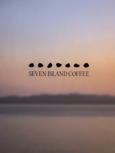 A serene sunset scene over a body of water with seven small islands in the distance, set against a cloudy sky