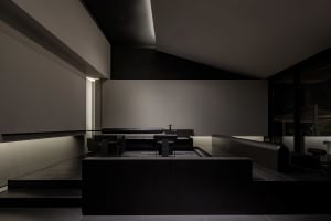 Empty modern bathroom with a sink, bench, and chairs, featuring a calm and serene atmosphere