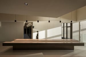 Well-lit lobby with a large countertop, two people, and inviting atmosphere
