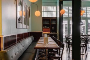 A restaurant dining area with multiple tables and chairs, creating a cozy and inviting atmosphere for guests