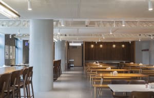 Empty restaurant with wooden tables and chairs, clean and well-organized, ready for customers
