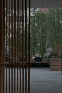 Cozy outdoor patio with a dining table and chairs, set for a meal with a candle, surrounded by evening atmosphere