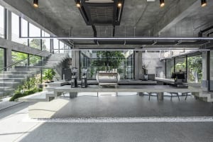 Industrial kitchen with modern appliances, concrete floors, and walls, and a functional yet stylish atmosphere