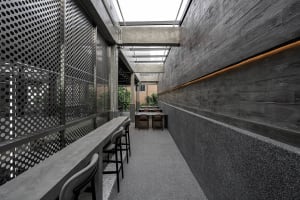 A dining area with a wooden table surrounded by four chairs, two on each side, in a comfortable and inviting space for socializing or meals