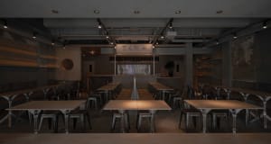 Dimly lit restaurant with metal tables and chairs, creating a cozy atmosphere