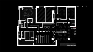 Black and white floor plan of a modern office building with multiple rooms and hallways, labeled with kitchen and lounge areas